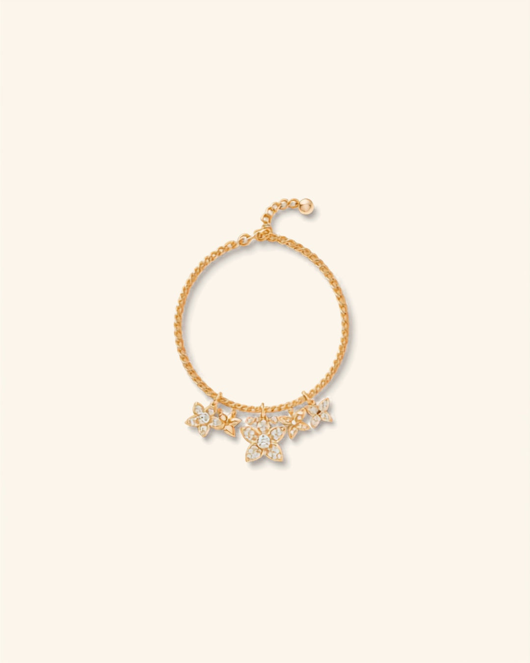 Gold flower charm rhinestone bracelet on cream background — Bare Gold
