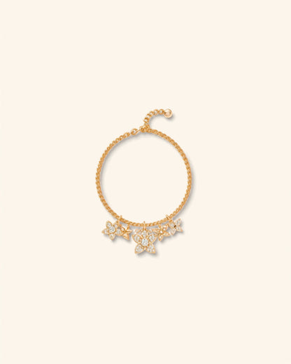 Gold flower charm rhinestone bracelet on cream background — Bare Gold