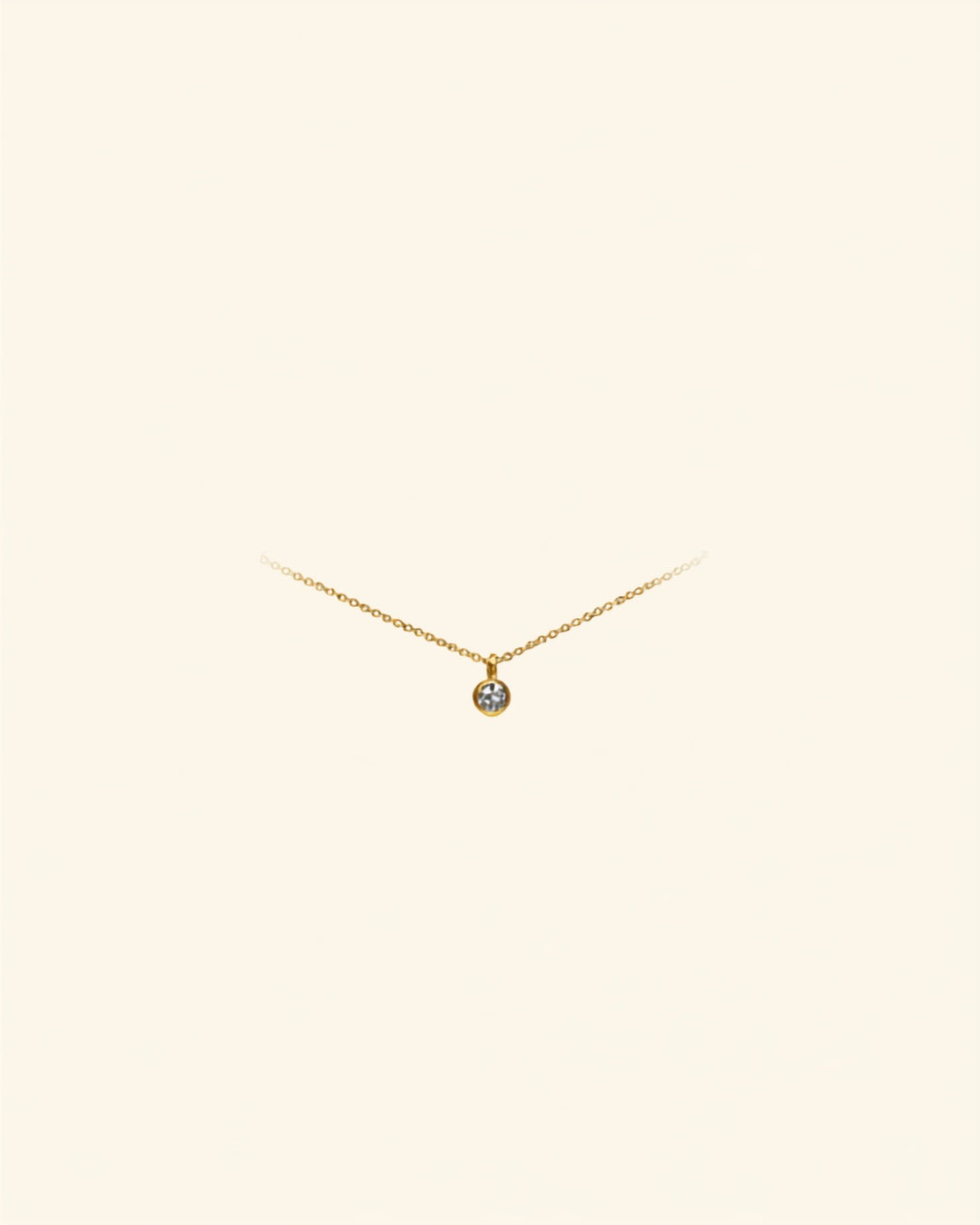 Initial letter gold anklet on cream background — Bare Gold waterproof jewelry