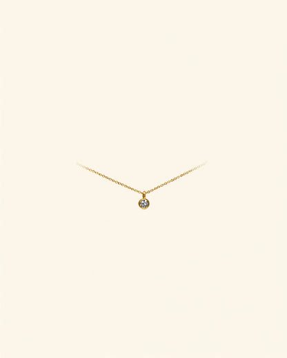 Initial letter gold anklet on cream background — Bare Gold waterproof jewelry