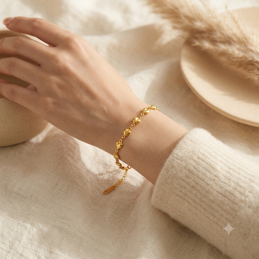 Gold heart chain bracelet worn on wrist — Bare Gold waterproof jewelry
